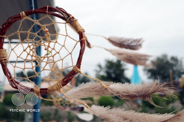 dream catcher hanging outside during the day