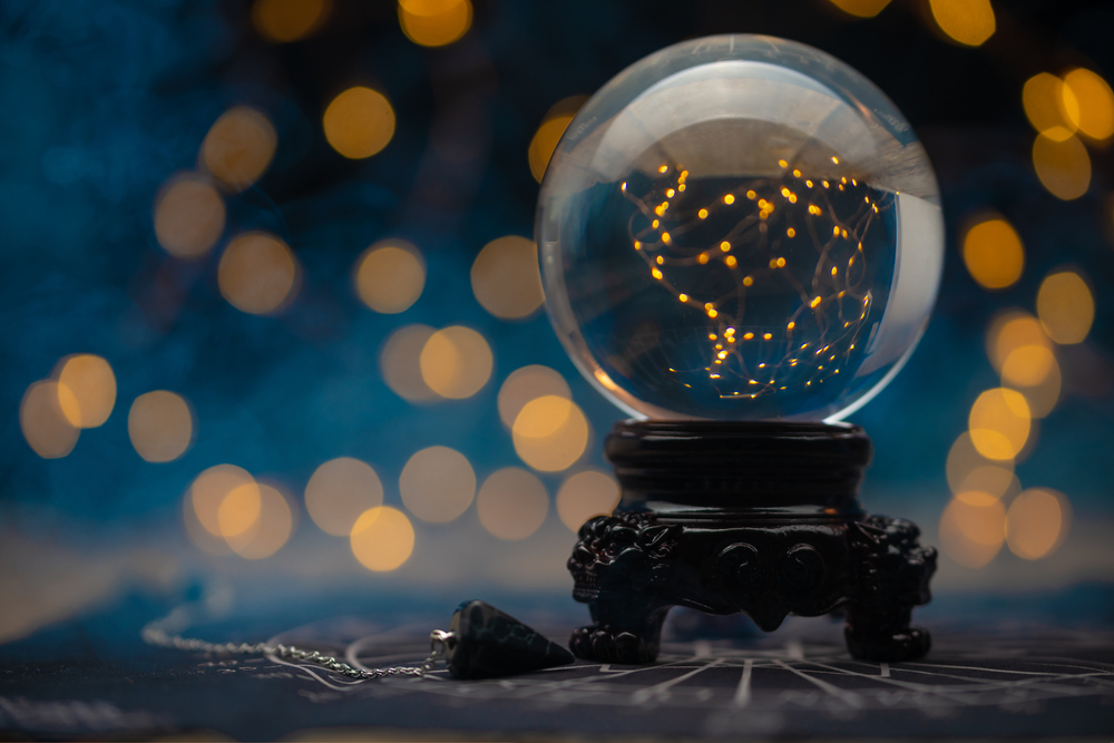 Magic crystal ball predictions set against a sparkling slightly blurred background.