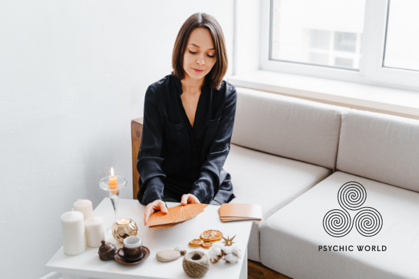 women-black-dress-reading-cards-candles