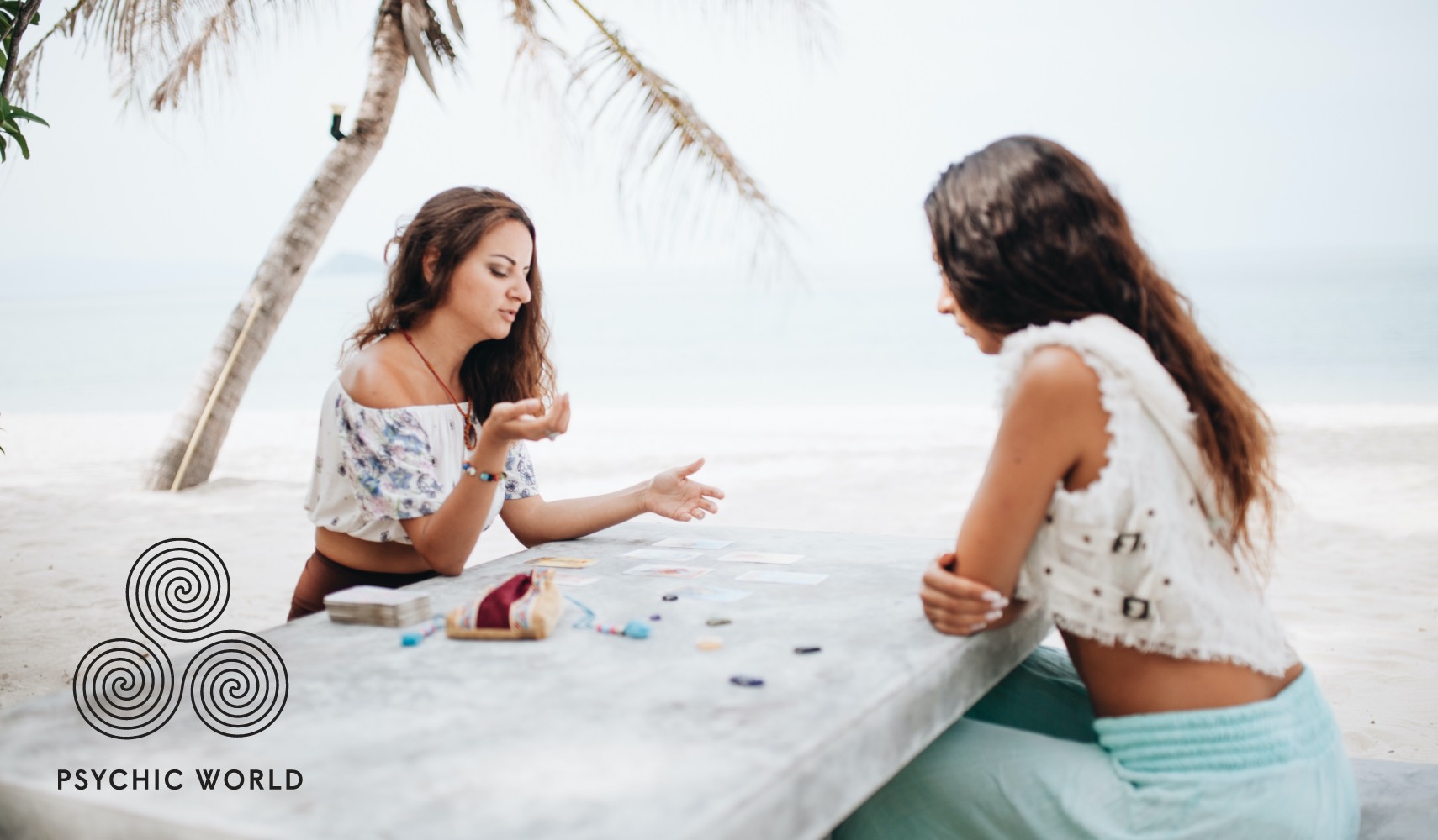 women angel card reading outside on the beach