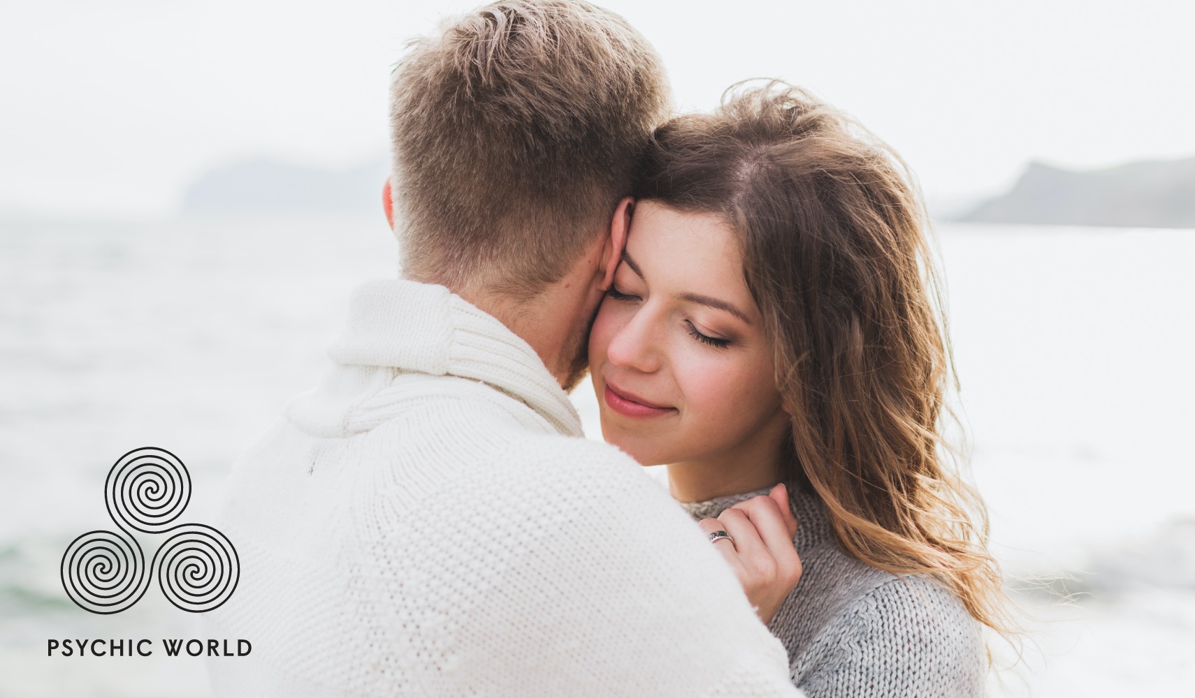 man and woman hugging each on the beach