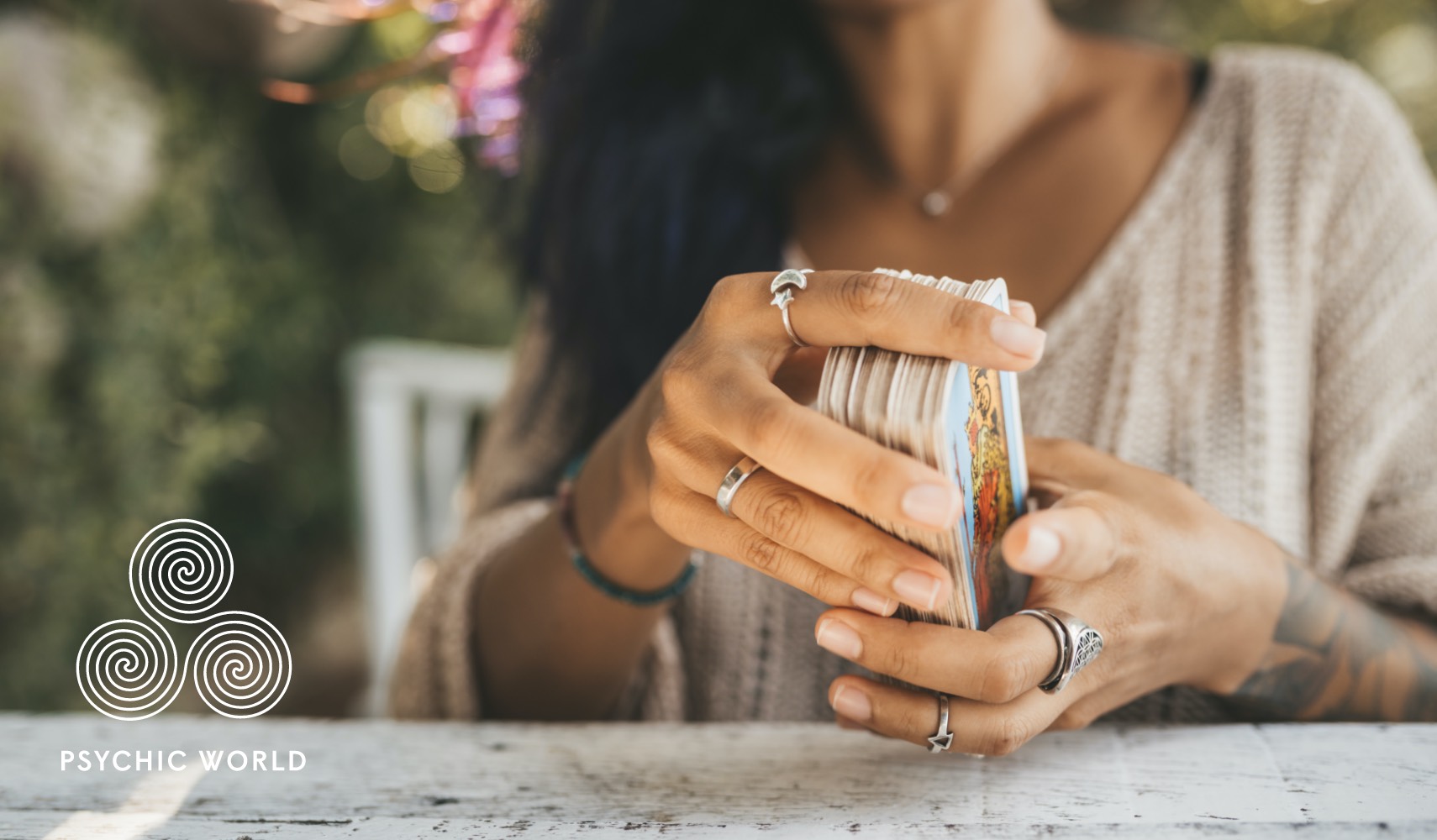 woman shuffling tarot cards outside